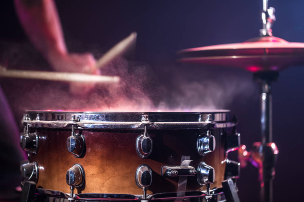 The drummer plays the drums. Beautiful blue and red background,  - Foto, Bild