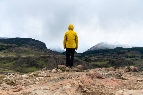 Alone hiker with yellow jacket admiring views of The Andes. Patagonia, Argentina - Valokuva, kuva