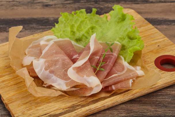Italian prosciutto pork meat over board - Photo, Image