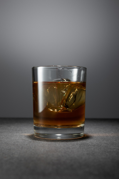 ice cubes in alcohol drink on grey background  - Photo, Image