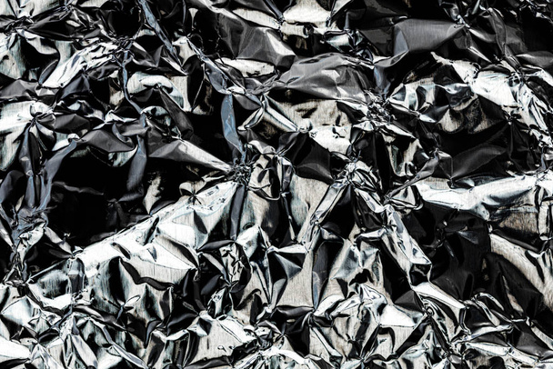 Texture of crumpled aluminum kitchen foil. Silver abstract backg - Photo, Image