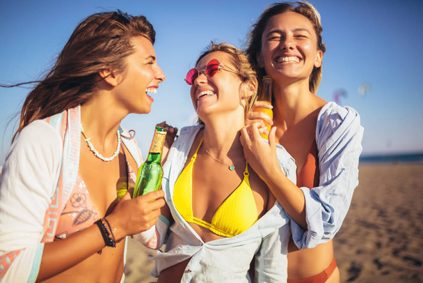 Group of three beautiful attractive young women having fun on th - Photo, image