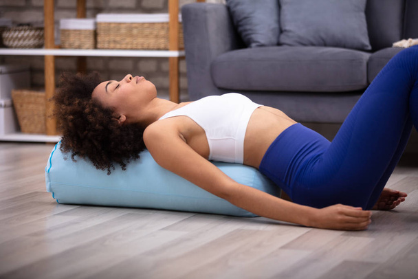 Close-up Of A Young African Woman Lying On Pillow Exercising - Photo, image