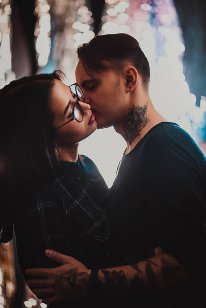 Beautiful couple kissing, on blurred smoke background. - Foto, Imagen