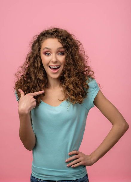 Attractive girl with curly hair isolated on pink - Photo, Image