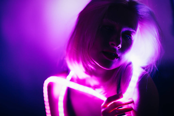 Portrait girl Strip Light LED tape on dark color background. - Foto, Imagem