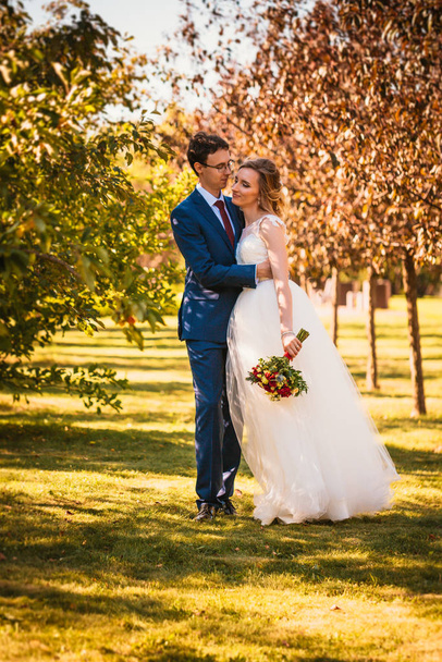 Beautiful stylish bride and groom on garden background. - Фото, зображення