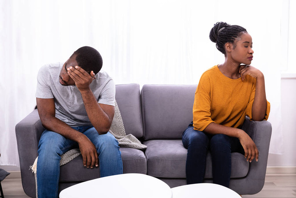 Upset Young African Couple Sitting On Sofa At Home - Fotoğraf, Görsel