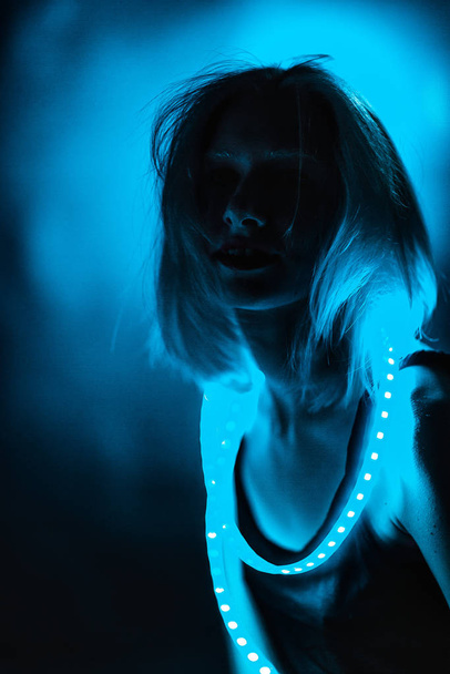 Portrait girl Strip Light LED tape on dark color background. - Foto, Imagem