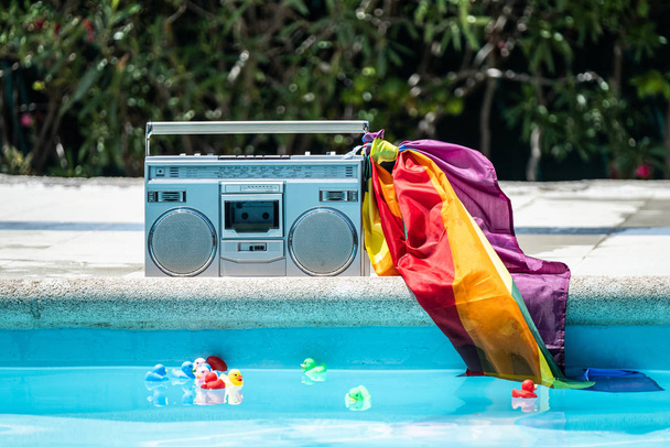 Group of friends sunbathing in the pool with old record player. lgtbi movement - Fotoğraf, Görsel