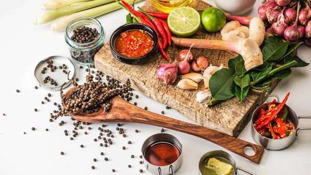 Spices for use as cooking ingredients on a wooden background with Fresh vegetables. Healthy food herbs. Organic vegetables on the table - 写真・画像