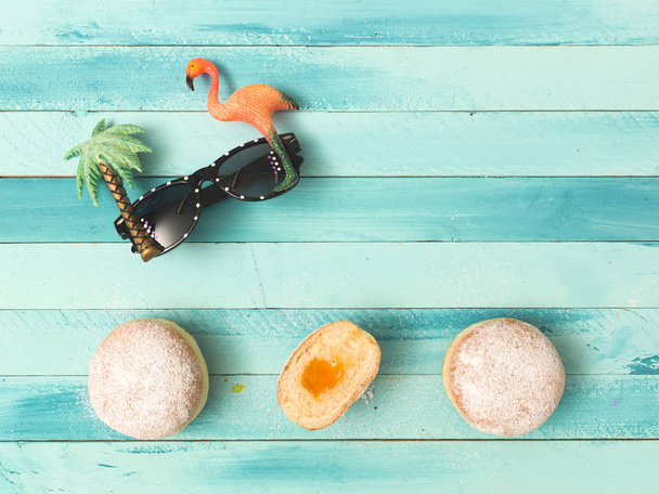 beautiful turquoise carnival background with doughnuts and some carnival items - Fotó, kép