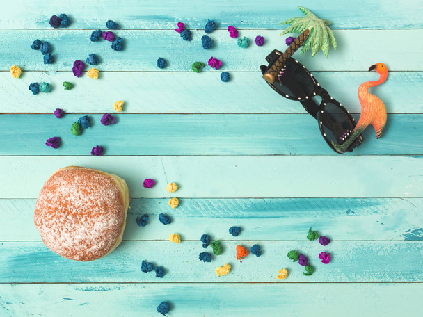 beautiful turquoise carnival background with doughnuts and some carnival items - Фото, зображення