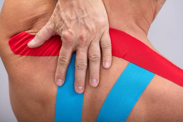 Shirtless Man With Physio Tape Applied On His Body. Body shape was altered during retouching - Φωτογραφία, εικόνα