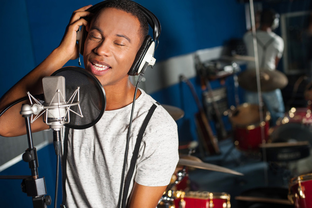 Singer recording a track in studio - Foto, imagen