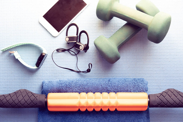 fitness and recovery equipment on a yoga mat - Photo, Image