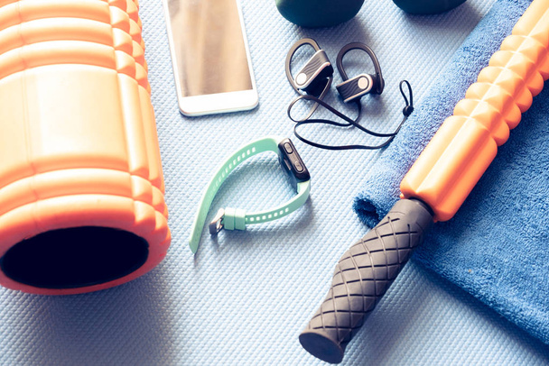 fitness and recovery equipment on a yoga mat - Photo, Image