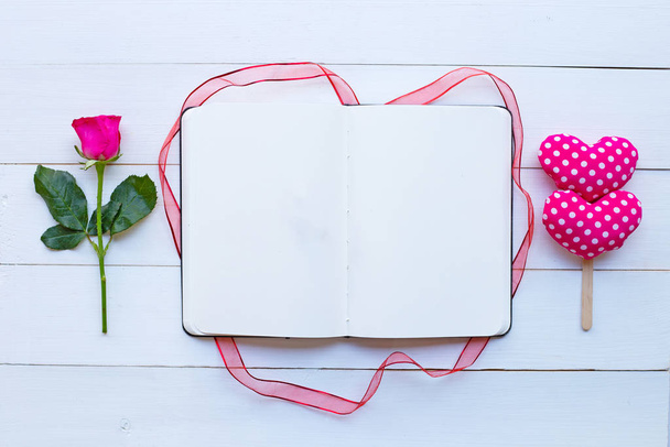 Diary notebook with rose and valentine's hearts on white wooden background. Concept for Valentine's Day - Foto, Imagen