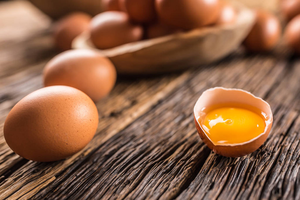 Fresh raw eggs on rustic wooden table - Fotografie, Obrázek