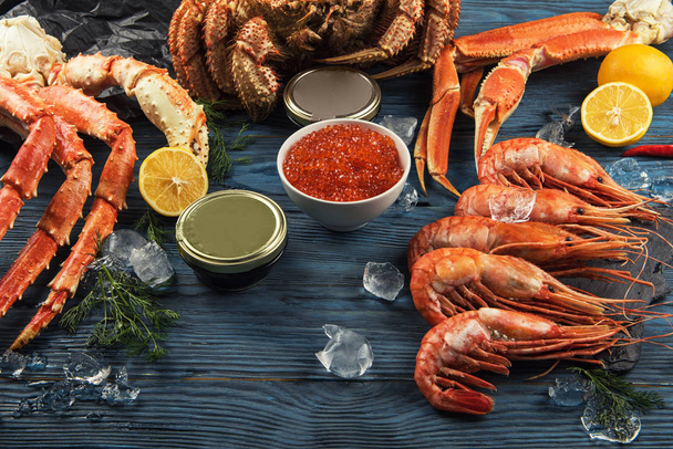 Set of seafood: red and black caviar, limb of hairy crab, limb of snow crab, far eastern kamchatka crab - Fotó, kép