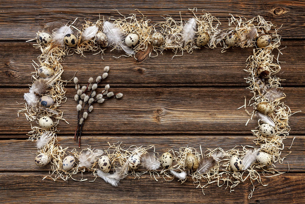 Quail eggs and willow on rustic wooden background.  - Photo, Image