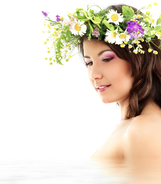 Young beautiful woman with garland of field fresh natural wild flowers - Fotografie, Obrázek