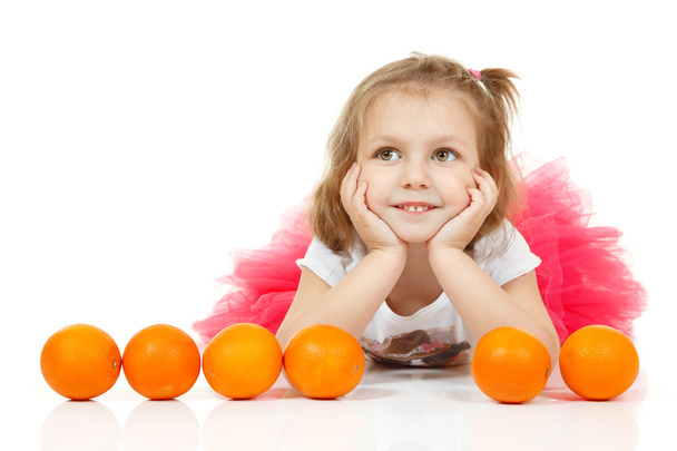 Cute little girl with oranges - Photo, image