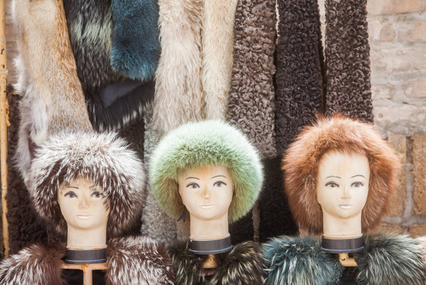 Color image of some mannequin heads wearing fur hats in a shop. - Valokuva, kuva
