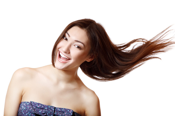 gyönyörű fiatal mosolygó nő repülő hosszú barna hajú szépség portréja - Fotó, kép