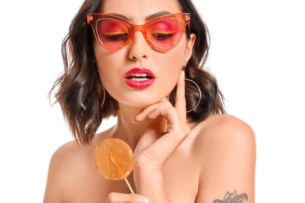 Beautiful young woman with lollipop on white background - Foto, Imagem