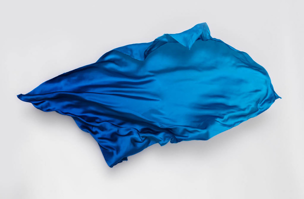 abstract piece of blue fabric flying, high-speed studio shot - Foto, afbeelding