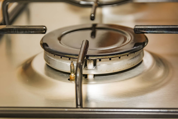 Close-up view of a stove burner in a metal kitchen. interior shot - Foto, Imagem