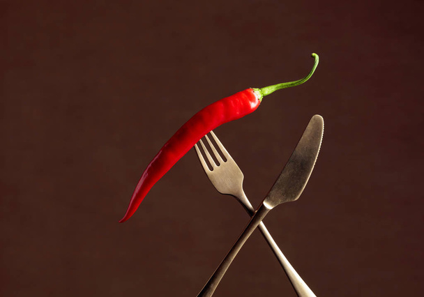 Hot chili red pepper on a fork. Spice concept.  - Fotoğraf, Görsel