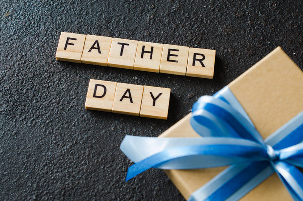 Happy Father's day greeting card with decorated gift box on dark background. Top view. - Fotoğraf, Görsel