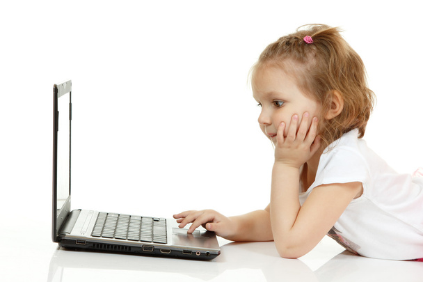 Adorable little girl using laptop - 写真・画像