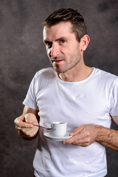 young dark haired man with espresso cup - Foto, Bild