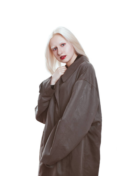 portrait of an albino girl in a raincoat in the studio. - Фото, зображення
