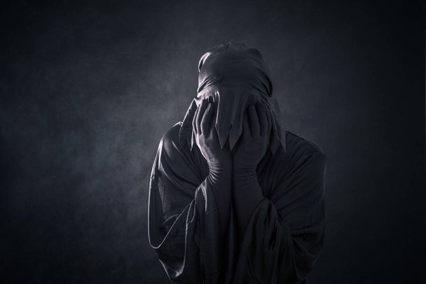 Scary figure in hooded cloak - Фото, изображение