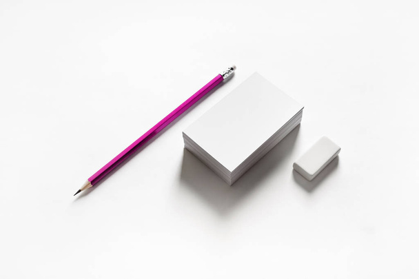 Blank business cards, pencil and eraser on paper background. Stationery template. - 写真・画像
