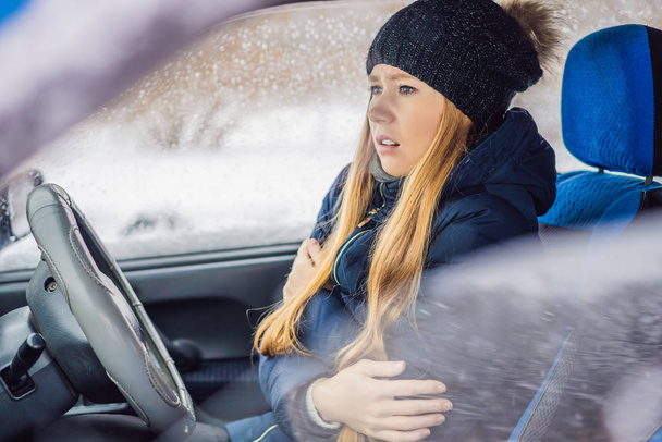 Woman in a car during a snowfall, problems on the road - Photo, Image