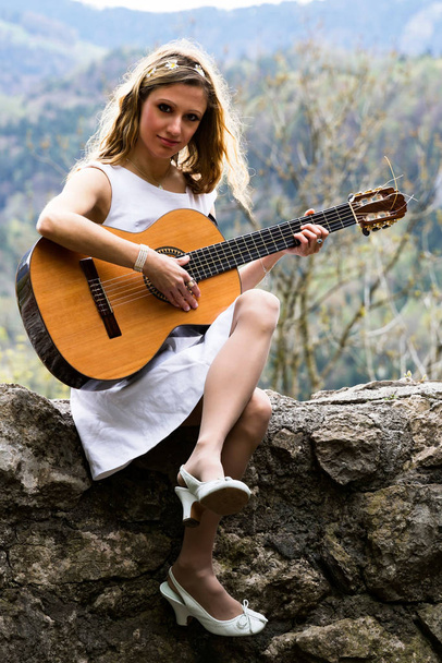 female guitarist on a lost place - Photo, Image