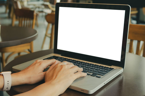Woman's hands using computer laptop with blank screen on desk. - 写真・画像
