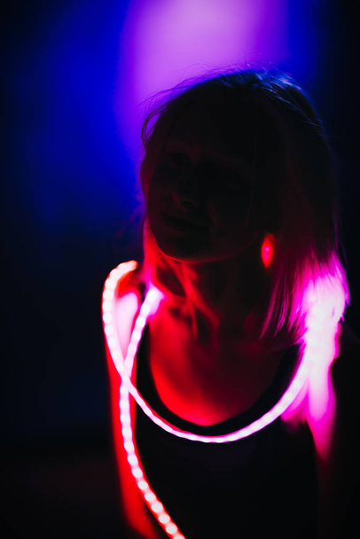 Portrait girl Strip Light LED tape on dark color background. - Foto, imagen