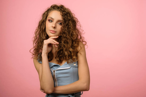 Closeup studio portrait of pretty girl with long curly hair - Photo, Image