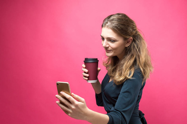 Glamor woman with a drink of coffee on a pink background. - Photo, image