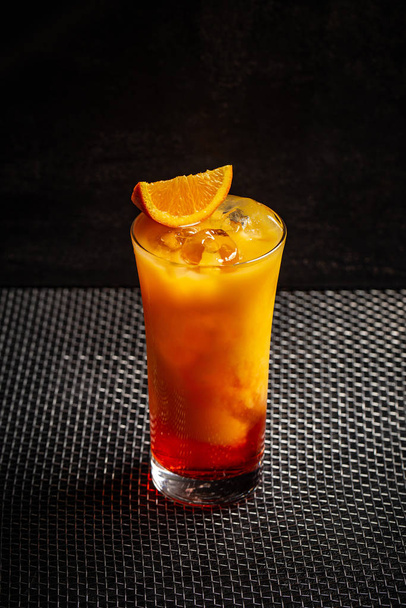 Glass of aperol orange cocktail on black background - Fotó, kép