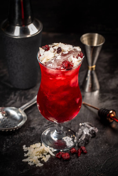 Red cocktail drink with ice, cocktail making bar tools on background - Photo, Image