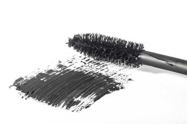 Mascara brush makes smear close-up isolated on white background - Фото, изображение