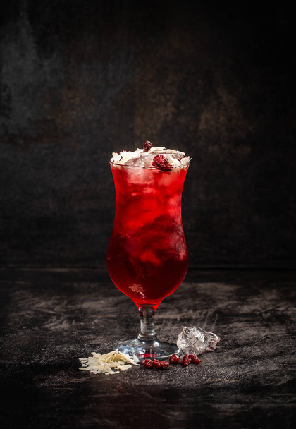 Fresh strawberry cocktail. Fresh summer cocktail with strawberry syrup and ice cubes, decorated with coconut shavings - Photo, Image