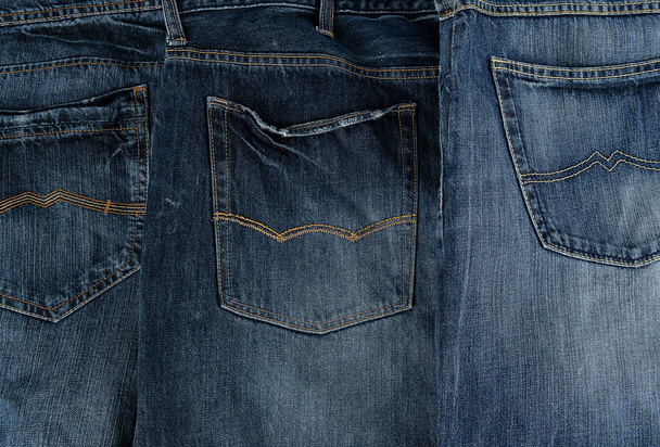 several other classic jeans folded in a row, back pocket - Foto, afbeelding